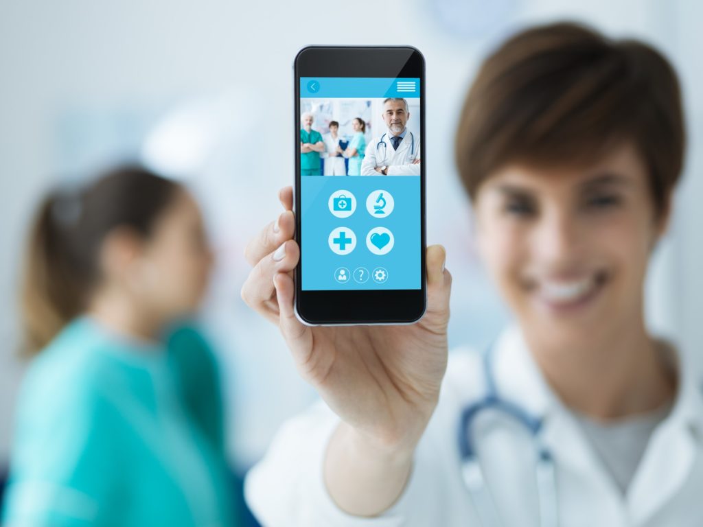 healthcare professional holding mobile device with patients application